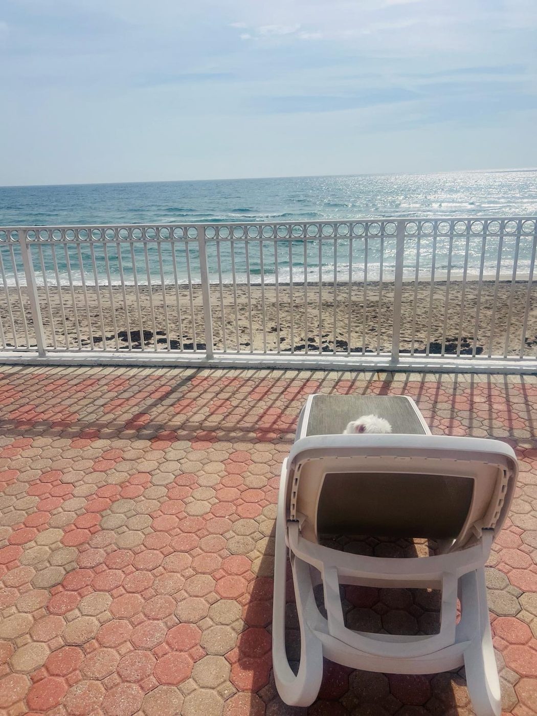 Direct beach access railing with lounge chair and ocean view