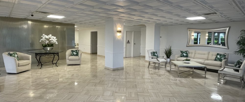 Concierge lobby at The Claridges Palm Beach with marble floors and refined seating