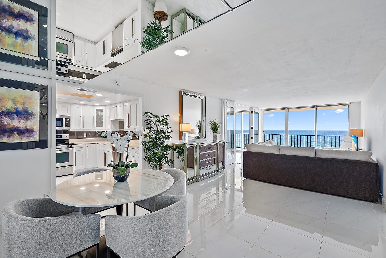 Open floor plan: kitchen, dining, living room with ocean view