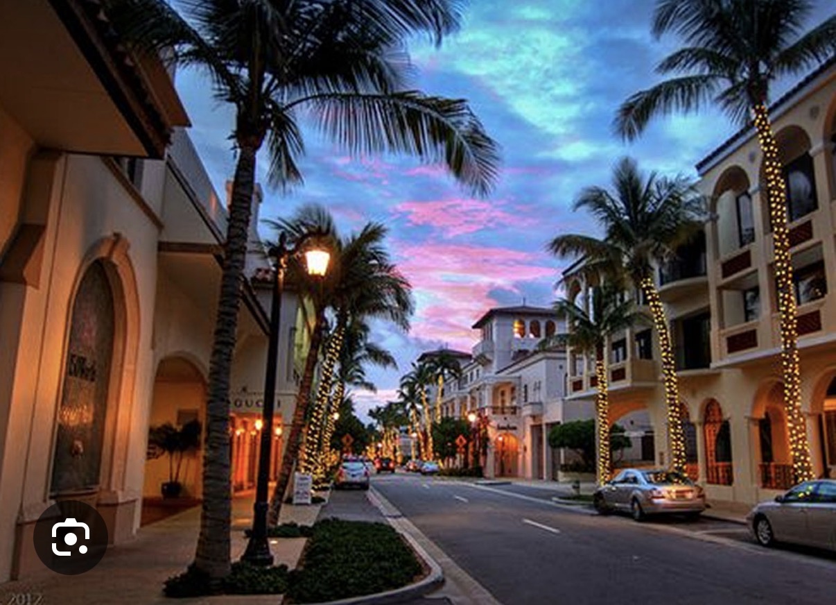 World-class dining along Worth Avenue Palm Beach with palm-lined storefronts at sunset